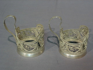 A pair of Eastern pierced white metal glass holders