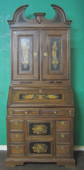A handsome Continental walnut bookcase on cabinet with broken pediment the upper section fitted various drawers and cupboards  enclosed by a pair of inlaid panelled doors, the base fitted 2 candle slides above a well fitted interior with numerous drawers, the base fitted 4 short drawers flanked by a pair of cupboards, raised on bracket feet 38"