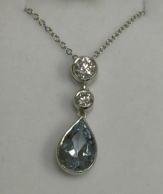 A lady's gold pendant set 2 diamonds above a tear cut aquamarine