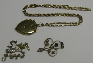 A gilt metal pendant hung on a gold chain and 2 pierced gold pendants