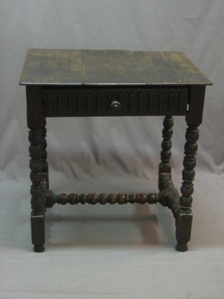 A 17th/18th Century oak low boy with panelled top, the base fitted a drawer, raised on turned and block supports 27"