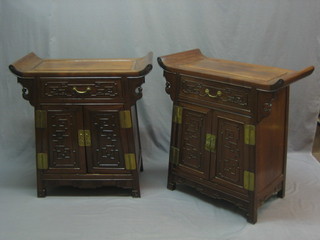 A pair of 20th Century Padouk wood cabinets fitted a drawer above double cupboard 30"