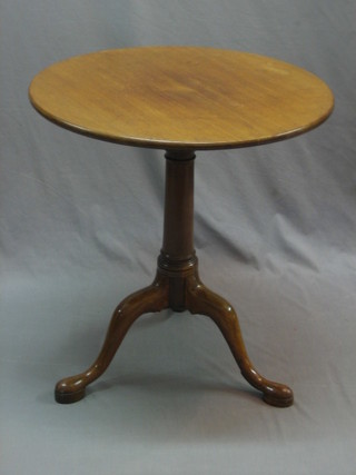A Georgian mahogany circular snap top tea table with bird cage action, raised on a gun barrel turned column and tripod supports 25"
