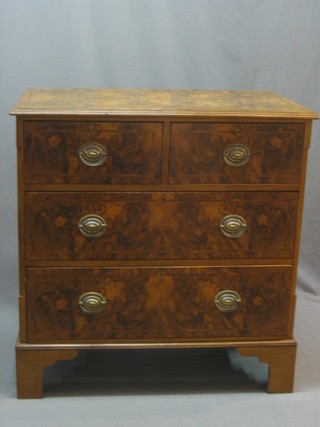 A Queen Anne style figured walnut chest of 2 short and 2 long drawers with canted corners, raised on bracket feet 36"