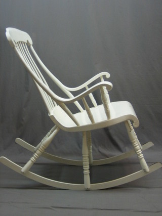 An American style white painted stick and bar back rocking chair raised on 6 turned supports