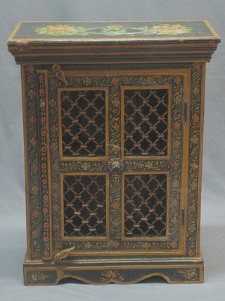 An Eastern painted cabinet enclosed by grilled panelled doors, raised on bracket feet 20"