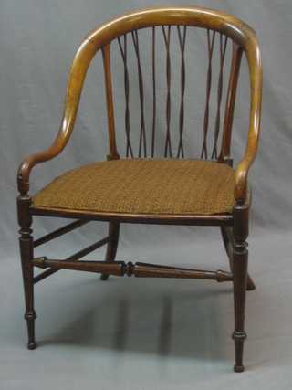 An Edwardian mahogany tub back chair with upholstered seat raised on turned supports