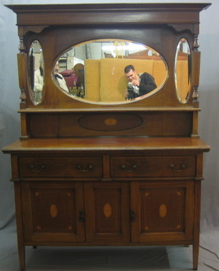 An Art Nouveau inlaid mahogany dresser with raised mirrored back, the base fitted 2 long drawers above a double cupboard 54"