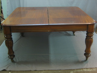A William IV mahogany extending dining table, raised on turned supports with 2 extra leaves 58"