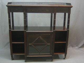 An Edwardian mahogany Chippendale style side cabinet with pierced three-quarter gallery, the top fitted 1 long drawer flanked by 2 short drawers, raised on turned columns, the base fitted a cupboard enclosed by a glazed panelled door flanked by recesses by Maple & Co, 48"