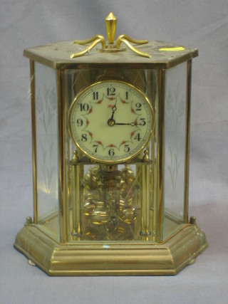 A 400 day clock contained in a gilt metal and glass lozenge shaped case