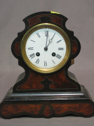 A Victorian French 8 day striking mantel clock with  enamelled dial and Roman numerals contained in an ebonised and walnut finished case
