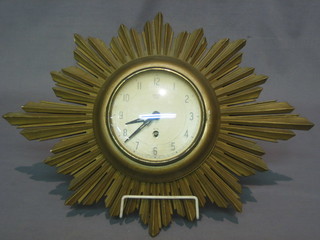 A 1930's Smiths 8 day wall clock with painted dial and Arabic numerals contained in a carved wooden sunburst case