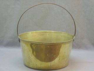 A brass warming pan with polished steel handle