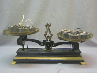 A pair of Continental brass and iron pand scales complete with 10 weights 50 grams - 2 kilograms