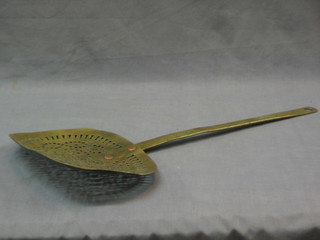 An oval pierced brass cream skimmer