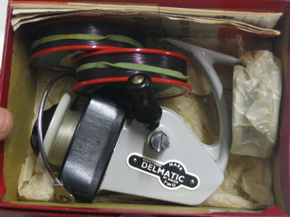 An Alcocks Delmatic Two fixed spool fishing reel boxed, with spare spools and instructions