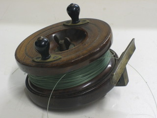A 19th Century mahogany and brass centre pin fishing reel 3 1/2"