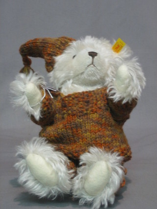 A modern Steiff white bear with articulated limbs complete with jumper and hat 9"