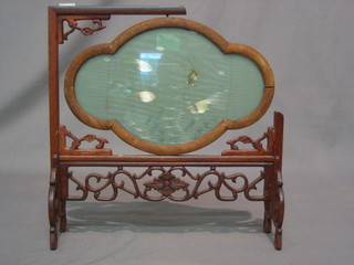 An Eastern table screen with silk panel depicting fish contained on a pierced hardwood stand 12"