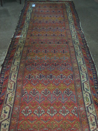 An orange ground Kelim rug with all over geometric design within multi row borders (some wear) 149" x 40"