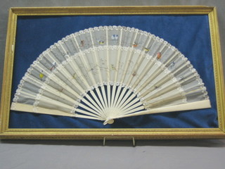 A fine quality 19th Century ivory fan with a painted silk panel decorated birds contained in a gilt frame