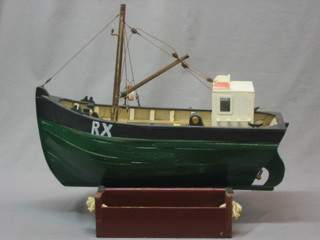 A wooden model of a fishing boat 21"