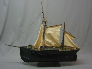 A wooden model of a 2 masted sailing ship 26"