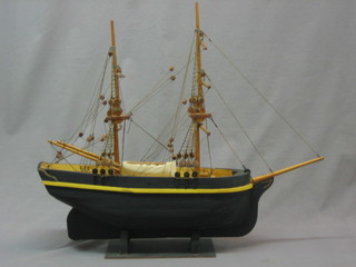 A wooden model of a twin masted sailing barge 20"
