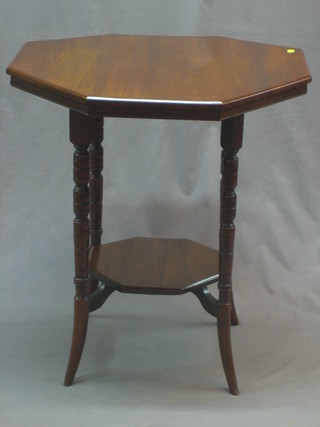 A Victorian octagonal walnut 2 tier occasional table raised on turned supports 24"