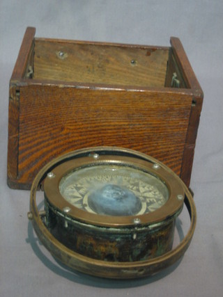 A binnacle ships compass contained in a wooden case