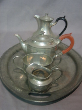 A 4 piece Hutton planished pewter tea service comprising teapot, sugar bowl and cream jug and an oval twin handled tea tray