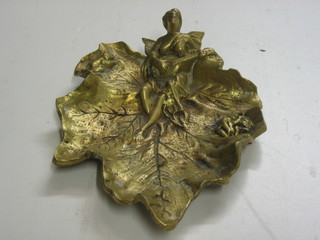 A gilt bronze ashtray in the form of leaf decorated a musical cherub 9"