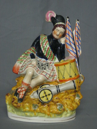A 19th Century Staffordshire figure of a sleeping Scots Soldier 10"