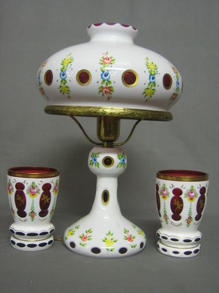 A Bohemian red overlay glass table lamp and a pair of matching goblets 6"