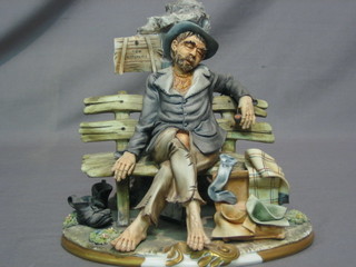A Capo di Monte figure of a seated tramp 8"