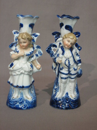 A pair of 19th Century blue and white porcelain candlesticks decorated boy and girl 7"
