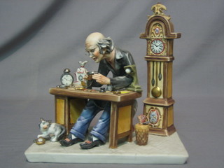 A Capo di Monte figure of a seated clock maker 9"