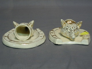 A pair of pottery wall pockets in the form of foxes masks 5"