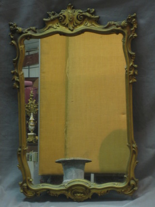 A 20th Century shaped plate mirror contained in a decorative gilt frame 29"
