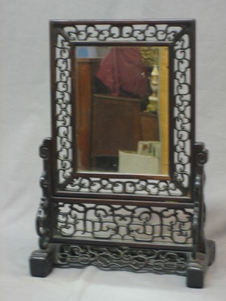 An Eastern rectangular plate table mirror contained in a pierced hardwood frame 17" x 10"