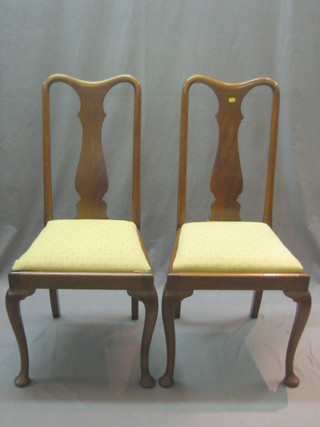 A pair of Queen Anne style mahogany splat back dining chairs with H framed stretchers, raised on cabriole supports