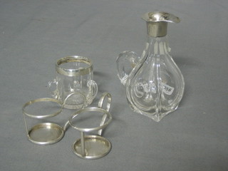 A glass match striker in the form of a tyg with silver mount, a small glass ewer with silver collar and 2 small silver glass holders