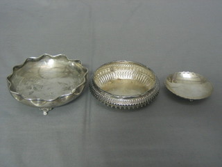 An Eastern silver bowl with wavy border on paw feet 5", an embossed Eastern silver dish 4" and a circular Continental silver dish on 3 bun feet 3"