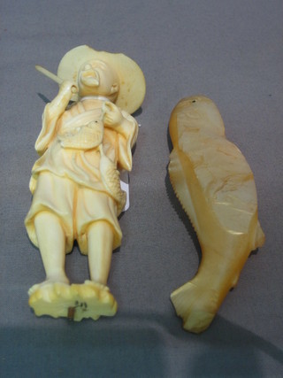 A carved Eastern figure of a standing fisherman and a carved mother of pearl figure of a fish 5" (f)