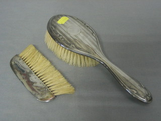 A silver backed hair brush and a silver backed clothes brush