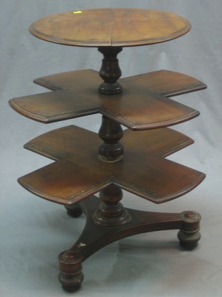 A Victorian mahogany circular sewing table, the base fitted 2 square revolving platforms raised on a triform base 17"