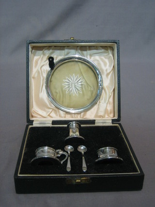 An Art Deco silver 6 piece condiment set comprising mustard pot, pepper pot, salt, 2 spoons and tray, Birmingham 1949, cased
