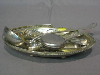 A circular metal tobacco box, a pierced silver plated cake basket and a small collection of flatware