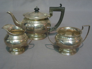 A 3 piece silver bachelor's tea service of circular form comprising teapot, twin handled sugar bowl and cream jug, Birmingham 1921, 21 ozs